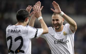 Real Madrid's French forward Karim Benzema (R) celebrates with his teammate Argentinian midfielder Angel Di Maria after scoring during the Spanish league "Clasico" football match Real Madrid CF vs FC Barcelona at the Santiago Bernabeu stadium in Madrid on March 23, 2014.  AFP PHOTO / DANI POZO        (Photo credit should read DANI POZO/AFP via Getty Images)