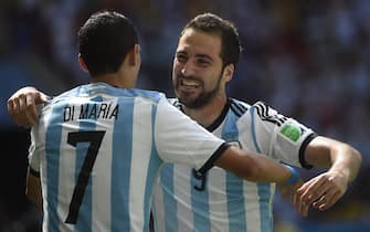 Argentina's forward Gonzalo Higuain (R) celebrates with Argentina's midfielder Angel Di Maria (L) after scoring during a quarter-final football match between Argentina and Belgium at the Mane Garrincha National Stadium in Brasilia during the 2014 FIFA World Cup on July 5, 2014.   AFP PHOTO / MARTIN BUREAU        (Photo credit should read MARTIN BUREAU/AFP via Getty Images)