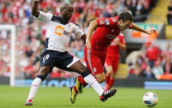 epa02883997 Liverpool's Stewart Downing (R) is tackled by Bolton Wanderers' Nigel Reo-Coker (L) during their English Premier League soccer match at the Anfield stadium in Liverpool, north west Britain, 27 August 2011. Liverpool won 3-1.  EPA/LINDSEY PARNABY NO ONLINE/INTERNET USE WITHOUT A LICENSE FROM THE FOOTBALL DATA CO.LTD.