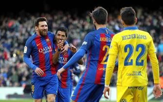 FC Barcelona's Uruguayan striker Luis Suarez (C) jubilates with his team mate, Leo Messi (L) and Portuguse midfielder Andre Gomes (2R) his goal against UD Las Palmas during the Primera Division soccer match played at Camp Nou stadium in Barcelona, Catalonia, Spain on 14 January 2017. EFE/Toni Albir