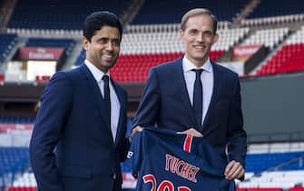 epaselect epa06752872 German coach Thomas Tuchel (R) and PSG president and CEO Nasser Al-Khelaifi (L) pose for photographs with a PSG jersey after a press conference for Tuchel's presentation as new head coach of Paris Saint-Germain (PSG) in Paris, France, 20 May 2018. French Ligue 1 champions Paris Saint-Germain have appointed Thomas Tuchel as new head coach to replace Unai Emery.  EPA/CHRISTOPHE PETIT TESSON