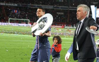 PARIS, FRANCE - MAY 18: Thiago Silva and Carlo Ancelotti of Paris Saint-Germain celebrate after defeating Stade Brestois 29 at the French League 1 match at Parc des Princes on May 18, 2013 in Paris, France. (Photo by Xavier Laine/Getty Images)
