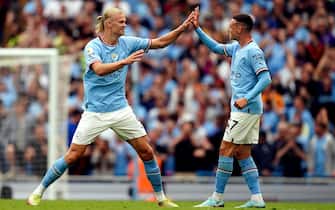 Manchester City's Erling Haaland celebrates scoring his sides second goal with Phil Foden (right) during the Premier League match at the Etihad Stadium, Manchester. Picture date: Saturday August 27, 2022.