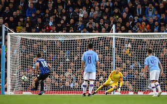 Manchester City's Brazilian goalkeeper Ederson (R) dives the wrong way as Atalanta's Ukrainian midfielder Ruslan Malinovskyi (L) scores the opening goal from the penalty spot during the UEFA Champions League Group C football match between Manchester City and Atalanta at the Etihad Stadium in Manchester, northwest England on October 22, 2019. (Photo by Paul ELLIS / AFP) (Photo by PAUL ELLIS/AFP via Getty Images)