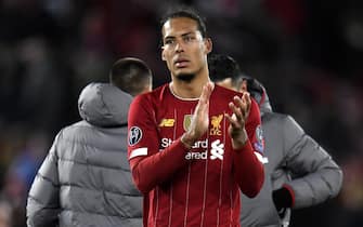 epa08287567 Virgil van Dijk of Liverpool applauds fans after the UEFA Champions League Round of 16, second leg match between Liverpool FC and Atletico Madrid in Liverpool, Britain, 11 March 2020.  EPA/PETER POWELL