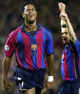 B16 - 20020220 - BARCELONA, CATALONIA, SPAIN : Barcelona's dutch striker Patrick Kluivert (L) jubilates after scoring against AS Roma during their Champions League group B soccer match at Nou Camp stadium in Barcelona, Wednesday 20 February 2002. The match ended 1-1 draw. Player at right is unidentified.  EPA PHOTO   EFE/ANDREU DALMAU/sj/mr