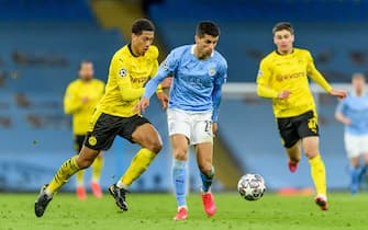 MANCHESTER, ENGLAND - APRIL 06: (BILD ZEITUNG OUT) Jude Bellingham of Borussia Dortmund and Joao Cancelo of Manchester City battle for the ball during the UEFA Champions League Quarter Final match between Manchester City and Borussia Dortmund at Manchester City Football Academy on April 6, 2021 in Manchester, United Kingdom. Sporting stadiums around the UK remain under strict restrictions due to the Coronavirus Pandemic as Government social distancing laws prohibit fans inside venues resulting in games being played behind closed doors. (Photo by Vincent Mignott/DeFodi Images via Getty Images)