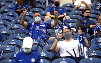 epa09235211 Chelsea fans wear protective face masks in the stands prior to the UEFA Champions League final between Manchester City and Chelsea FC in Porto, Portugal, 29 May 2021.  EPA/Pierre-Philippe Marcou / POOL