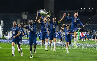 Chelsea's players celebrate with the trophy after winning the UEFA Champions League final football match between Manchester City and Chelsea FC at the Dragao stadium in Porto on May 29, 2021. (Photo by David Ramos / POOL / AFP) (Photo by DAVID RAMOS/POOL/AFP via Getty Images)