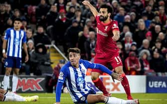 epa09601731 Liverpool's Mo Salah (R) celebrates after scoring the 2-0 lead during the UEFA Champions League group B soccer match between Liverpool FC and FC Porto in Liverpool, Britain, 24 November 2021.  EPA/Tim Keeton