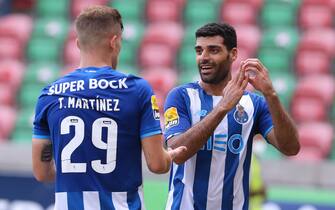 epa09425147 FC Porto's Mehdi Taremi (R) celebrates after scoring a goal during the Portuguese First League soccer match between Maritimo and FC Porto at Maritimo's stadium in Funchal, Madeira Island, Portugal, 22 August 2021.  EPA/GREGORIO CUNHA