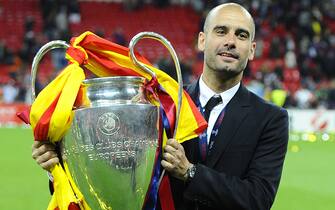 Barcelona's Spanish coach Josep Guardiola celebrates with the trophy at the end of the UEFA Champions League final football match FC Barcelona vs. Manchester United, on May 28, 2011 at Wembley stadium in London.Barcelona won 3 to 1. AFP PHOTO / CARL DE SOUZA (Photo credit should read CARL DE SOUZA/AFP via Getty Images)
