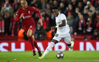 epa10482476 Fabinho (L) of Liverpool in action against Vinicius Junior of Real Madrid during the UEFA Champions League, Round of 16, 1st leg match between Liverpool FC and Real Madrid in Liverpool, Britain, 21 February 2023.  EPA/Peter Powell