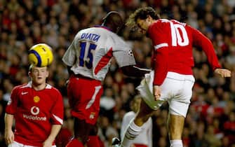 Manchester United's Ruud van Nistelrooy heads down to score their second goal after good work from Rio Ferdinand, against Olympique Lyonnais in the European Champions League Group D match at Old Trafford, Manchester.