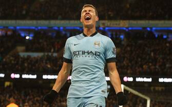 epa04631076 Manchester City's Edin Dzeko celebrates scoring the 3-0 goal during the English Premier League soccer match between Manchester City and Newcastle United at the Etihad stadium in Manchester, Britain 21 February 2015.  EPA/LINDSEY PARNABY DataCo terms and conditions apply. http://www.epa.eu/files/Terms%20and%20Conditions/DataCo_Terms_and_Conditions.pdf
