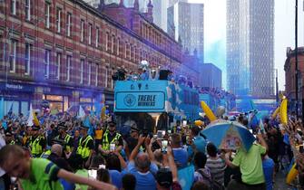 A general view of the bus driving past fans during the Treble Parade in Manchester. Manchester City completed the treble (Champions League, Premier League and FA Cup) after a 1-0 victory over Inter Milan in Istanbul secured them Champions League glory. Picture date: Monday June 12, 2023.