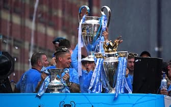 Manchester City's Kalvin Phillips with the Emirates FA Cup Trophy, Phil Foden with the Champions League trophy, and Bernardo Silva with the Premier League trophy during the Treble Parade in Manchester. Manchester City completed the treble (Champions League, Premier League and FA Cup) after a 1-0 victory over Inter Milan in Istanbul secured them Champions League glory. Picture date: Monday June 12, 2023.