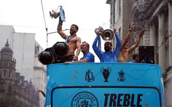 Manchester City's Ruben Dias, Ilkay Gundogan, and Erling Haaland celebrate during the Treble Parade in Manchester. Manchester City completed the treble (Champions League, Premier League and FA Cup) after a 1-0 victory over Inter Milan in Istanbul secured them Champions League glory. Picture date: Monday June 12, 2023.