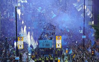 A general view of the team buses passing by fans during the Treble Parade in Manchester. Manchester City completed the treble (Champions League, Premier League and FA Cup) after a 1-0 victory over Inter Milan in Istanbul secured them Champions League glory. Picture date: Monday June 12, 2023.