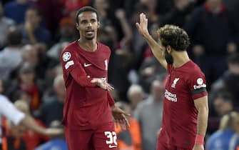epa10182462 Joel Matip (L) of Liverpool celebrates with teammate Mohamed salah (R) after scoring the 2-1 lead during the UEFA Champions League group A soccer match between Liverpool FC and Ajax Amsterdam in Liverpool, Britain, 13 September 2022.  EPA/PETER POWELL