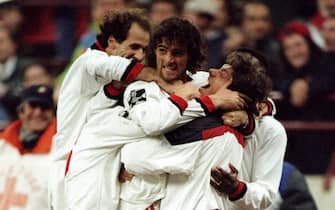 1995:  Marco Simone of AC Milan celebrates his goal with team mates during a match against Benfica at the Guiseppe Meazza Stadium in San Siro, Milan, Italy. \ Mandatory Credit: Clive  Brunskill/Allsport