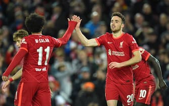 epa09562086 Liverpool's Diogo Jota (R) celebrates with teammate Mohamed Salah (L) after scoring the 1-0 lead during the UEFA Champions League group B soccer match between Liverpool FC and Atletico Madrid in Liverpool, Britain, 03 November 2021.  EPA/Peter Powell