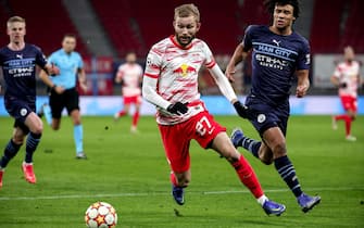 epa09627672 Leipzig's Konrad Laimer (C) in action against Manchester City's Nathan Ake (R) during the UEFA Champions League group A soccer match between RB Leipzig and Manchester City at Red Bull Arena in Leipzig, Germany, 07 December 2021.  EPA/FILIP SINGER