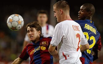 FC Barcelona's Bojan Krkic (L) and Eric Abidal vies with Olympique Lyonnais' Francois Clerc (C) during their Champions League football match at the Nou Camp in Barcelona 19 September 2007. AFP PHOTO/CESAR RANGEL (Photo credit should read CESAR RANGEL/AFP via Getty Images)