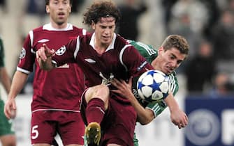 Panathinaikos' Charis Mavrias (R) fights for the ball with Rubin Kazan's Cristian Ansaldi during their group D champions league football game at the Athens Olympic stadium on October 20, 2010. AFP PHOTO / Aris Messinis (Photo credit should read ARIS MESSINIS/AFP via Getty Images)
