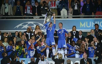 Chelsea's British defender John Terry (C) holds the trophy after the UEFA Champions League final football match between FC Bayern Muenchen and Chelsea FC on May 19, 2012 at the Fussball Arena stadium in Munich. Chelsea won 4-3 in the penalty phase. AFP PHOTO / ADRAN DENNIS        (Photo credit should read ADRIAN DENNIS/AFP/GettyImages)