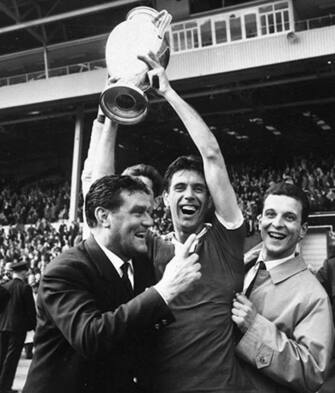 Cesare Maldini, the Milan captain holds the European Cup aloft with manager Nereo Rocco after AC Milan beat Benfica of Portugal 2-1 in the final of the 1963 European Cup at Wembley stadium in London on 22nd May 1963. (Photo by Evening Standard/Getty Images)