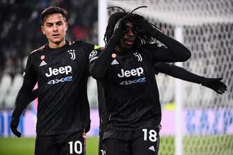 Juventus' Italian forward Moise Kean (C) celebrates next to Juventus' Argentine forward Paulo Dybala after opening the scoring during the UEFA Champions League Group H football match between Juventus and Malmo on December 8, 2021 at the Juventus stadium in Turin. (Photo by Marco BERTORELLO / AFP) (Photo by MARCO BERTORELLO/AFP via Getty Images)