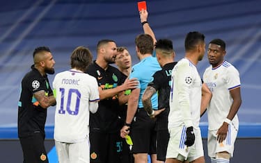 German referee Felix Brych presents a red card to Inter Milan's Italian midfielder Nicolo Barella (C) during the UEFA Champions League first round group D football match between Real Madrid and Inter Milan at the Santiago Bernabeu stadium in Madrid on December 7, 2021. (Photo by OSCAR DEL POZO / AFP) (Photo by OSCAR DEL POZO/AFP via Getty Images)