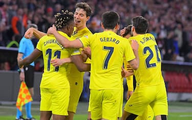Villarreal's Nigerian midfielder Samuel Chukwueze (L) celebrates scoring the 1-1 with his team-mates during the UEFA Champions League quarter-final, second leg football match FC Bayern Munich v FC Villarreal in Munich, southern Germany on April 12, 2022. (Photo by Jose Jordan / AFP) (Photo by JOSE JORDAN/AFP via Getty Images)