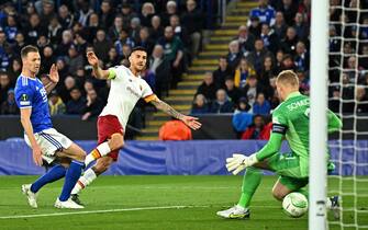 Roma's Italian midfielder Lorenzo Pellegrini (C) shoots through Leicester City's Danish goalkeeper Kasper Schmeichel (R) to score the opening goal of the UEFA Conference League semi-final first leg football match between Leicester City and Roma at King Power Stadium, in Leicester, on April 28, 2022. (Photo by Oli SCARFF / AFP) (Photo by OLI SCARFF/AFP via Getty Images)