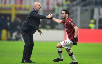 AC Milan's Turkish forward Hakan Calhanoglu celebrates scoring his team's second goal with AC Milan's Italian head coach Stefano Pioli during the Italian Cup (Coppa Italia) quarter final football match AC Milan vs Torino on January 28, 2020 at San Siro stadium in Milan. (Photo by MIGUEL MEDINA / AFP) (Photo by MIGUEL MEDINA/AFP via Getty Images)