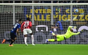 Inter Milan's Argentine forward Lautaro Martinez (L) scores the opening goal past AC Milan's French goalkeeper Mike Maignan (R) during the Italian Cup (Coppa Italia) semifinal, second leg football match between Inter and AC Milan on April 19, 2022 at the San Siro stadium in Milan. (Photo by MIGUEL MEDINA / AFP) (Photo by MIGUEL MEDINA/AFP via Getty Images)