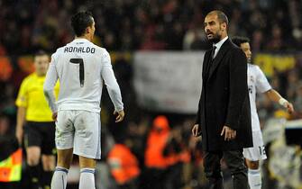 Real Madrid's Portuguese forward Cristiano Ronaldo (L) watches Barcelona's coach Josep Guardiola during the Spanish league "clasico" football match FC Barcelona vs Real Madrid at Camp Nou stadium on November 29, 2010 in Barcelona. Barcelona won 5-0.     AFP PHOTO/ JAVIER SORIANO (Photo credit should read JAVIER SORIANO/AFP via Getty Images)