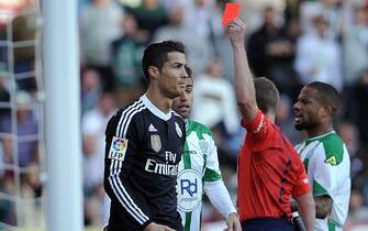 Real Madrid's Portuguese forward Cristiano Ronaldo (L) is handed a red card during the Spanish league football match Cordoba CF vs Real Madrid CF at the Nuevo Arcangel stadium on January 24, 2015.     AFP PHOTO / CRISTINA QUICLER        (Photo credit should read CRISTINA QUICLER/AFP via Getty Images)