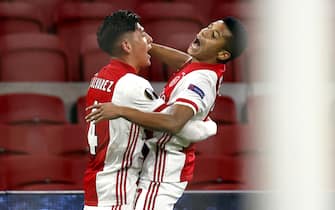 epa09036628 David Neres (R) of Ajax celebrates with teammate Edson Alvarez (L) after scoring the 2-1 lead during the UEFA Europa League round of 32, second leg soccer match between between Ajax Amsterdam and Lille OSC at the Johan Cruijff Arena in Amsterdam, Netherlands, 25 February 2021.  EPA/MAURICE VAN STEEN