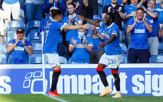 epa09365497 Fashion Sakala (R) of Rangers celebrates with teammate Ianis Hagi (L) after scoring the 1-1 equalizer during the pre-season friendly test soccer match between Glasgow Rangers and Real Madrid at Ibrox Stadium in Glasgow, Britain, 25 July 2021.  EPA/Robert Perry