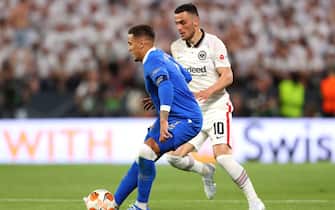 SEVILLE, SPAIN - MAY 18: James Tavernier of Rangers is challenged by Filip Kostic of Eintracht Frankfurt during the UEFA Europa League final match between Eintracht Frankfurt and Rangers FC at Estadio Ramon Sanchez Pizjuan on May 18, 2022 in Seville, Spain. (Photo by Fran Santiago - UEFA/UEFA via Getty Images)