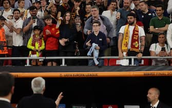 epa10666046 Roma head coach Jose Mourinho (bottom L) gives away his medal to a young fan after losing the UEFA Europa League final between Sevilla FC and AS Roma, in Budapest, Hungary, 01 June 2023. Sevilla won the final with 4-1 on penalties.  EPA/ANNA SZILAGYI