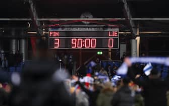 HELSINKI, FINLAND - NOVEMBER 15: Fans celebrate on the pitch as the Scoreboard showing the final score as 3-0 to Finland confirming qualification to Euro 2020 during the UEFA Euro 2020 Qualifier between Finland and Liechtenstein on November 15, 2019 in Helsinki, Finland. (Photo by James Williamson - AMA/Getty Images)