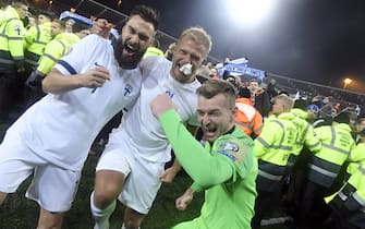 Finnish captain Tim Sparv (L) celebrates with Paulus Arajuuri and goalkeeper Lukas Hradecky after the UEFA Euro 2020 Group J qualification football match between Finland and Liechtenstein in Helsinki, Finland, on November 15, 2019. - Finland has qualified for the first time for a major football tournament. (Photo by Markku Ulander / Lehtikuva / AFP) / Finland OUT (Photo by MARKKU ULANDER/Lehtikuva/AFP via Getty Images)