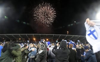 Finnish fans invade the pitch as they celebrate the victory as fireworks are set off after the UEFA Euro 2020 Group J qualification football match between Finland and Liechtenstein in Helsinki, Finland, on November 15, 2019. - Finland has qualified for the first time for a major football tournament. (Photo by Markku Ulander / Lehtikuva / AFP) / Finland OUT (Photo by MARKKU ULANDER/Lehtikuva/AFP via Getty Images)