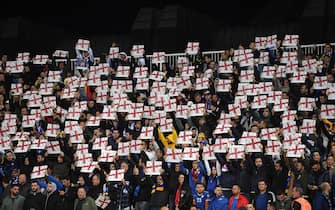 PRISTINA, KOSOVO - NOVEMBER 17: Fans hold up England flags during the UEFA Euro 2020 Qualifier between Kosovo and England at the Pristina City Stadium on November 17, 2019 in Pristina, Kosovo. (Photo by Michael Regan/Getty Images)