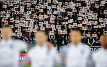 Kosovo fans hold up England flags as England's anthem 'God save the queen' is being played during the UEFA Euro 2020 qualifying Group A football match between Kosovo and England at the Fadil Vokrri stadium in Prishtina on November 17, 2019. (Photo by Armend NIMANI / AFP) (Photo by ARMEND NIMANI/AFP via Getty Images)