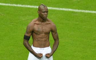 Italian forward Mario Balotelli celebrates after scoring the second goal during the Euro 2012 football championships semi-final match Germany vs Italy on June 28, 2012 at the National Stadium in Warsaw.   AFP PHOTO / GABRIEL BOUYS        (Photo credit should read GABRIEL BOUYS/AFP/GettyImages)