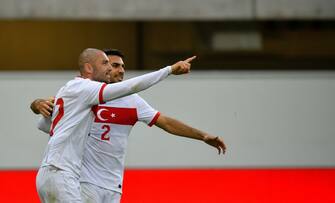 Turkey's forward Burak Yilmaz (L) celebrates with Turkey's defender Zeki Celik scoring the 1-0 during the friendly football match Turkey vs Moldova in Paderborn, western Germany on June 3, 2021, in preparation for the UEFA European Championships. (Photo by SASCHA SCHUERMANN / AFP) (Photo by SASCHA SCHUERMANN/AFP via Getty Images)